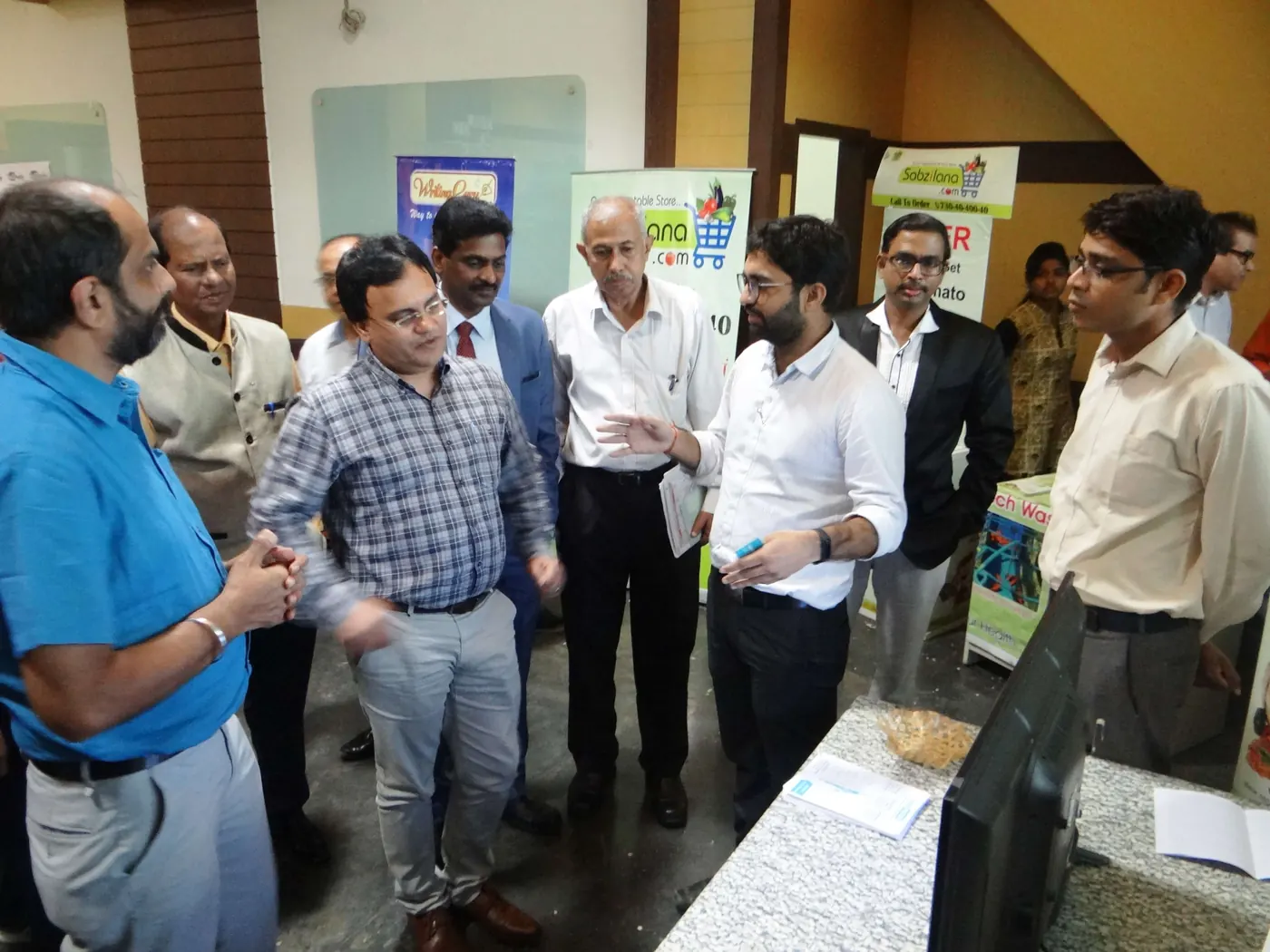 Founders and mentors networking at a Lemon Ideas startup display